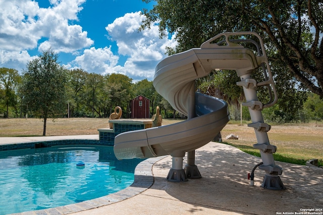 view of pool with a yard