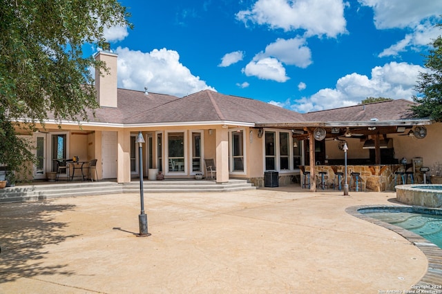 back of property with a patio