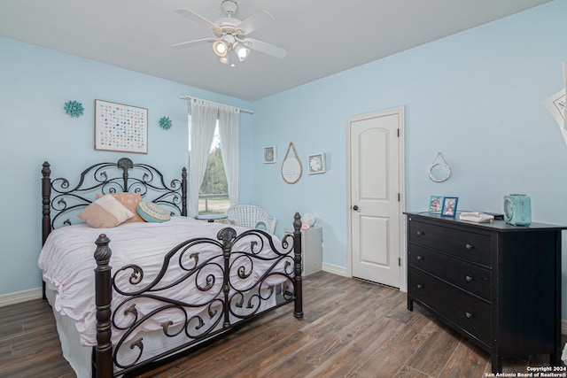 bedroom with ceiling fan and dark hardwood / wood-style flooring