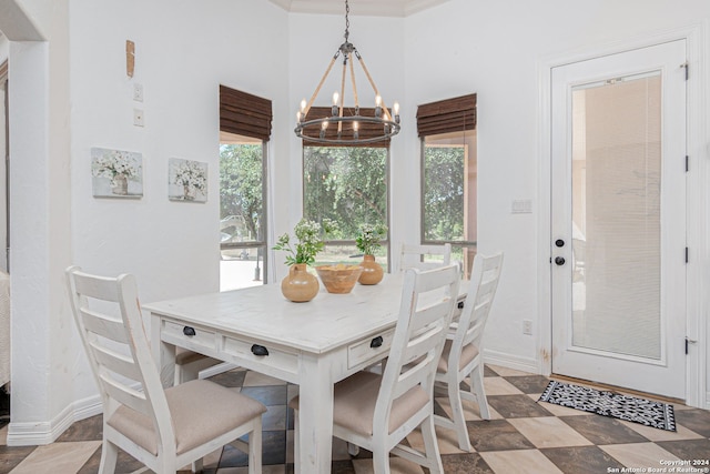 dining area featuring a notable chandelier and crown molding