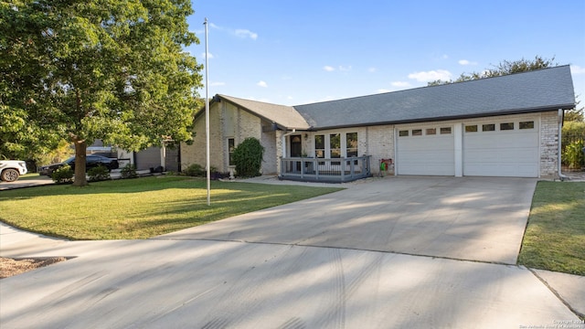 ranch-style home featuring a front yard and a garage