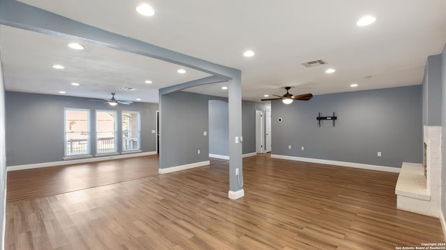 unfurnished living room with ceiling fan and light hardwood / wood-style floors