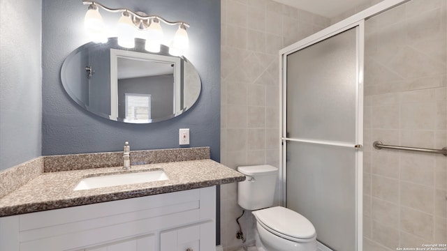 bathroom featuring walk in shower, vanity, and toilet