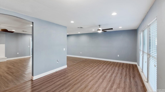 12743 S El Sonteo St, San Antonio, TX 78233 - empty room featuring a ceiling fan, wood finished floors, arched walkways, baseboards, and recessed lighting