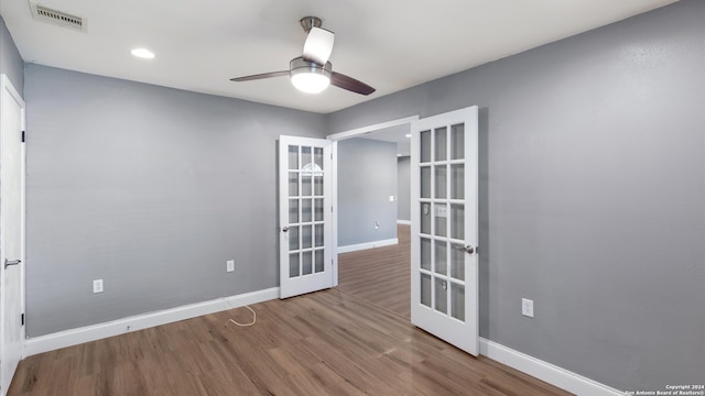 spare room with light wood-type flooring, ceiling fan, and french doors