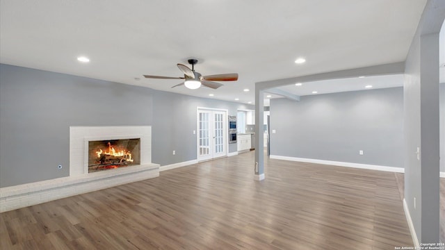 12743 S El Sonteo St, San Antonio, TX 78233 - unfurnished living room featuring wood finished floors, a ceiling fan, recessed lighting, baseboards, and a fireplace