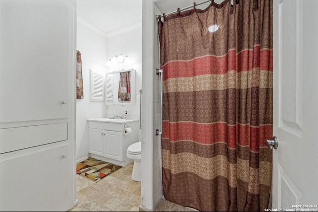 bathroom featuring curtained shower, ornamental molding, vanity, and toilet