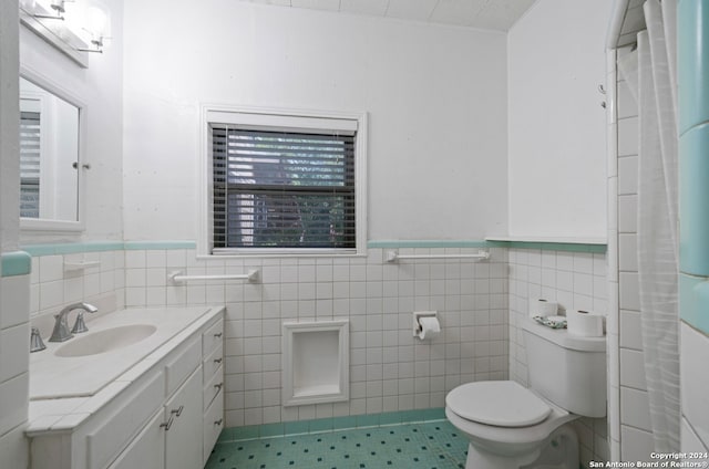 bathroom with vanity, tile walls, toilet, and tile patterned floors