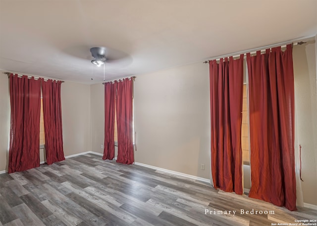 spare room featuring wood-type flooring and ceiling fan