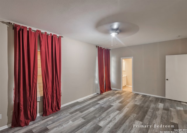 empty room featuring ceiling fan and hardwood / wood-style flooring