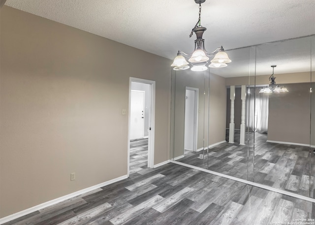 unfurnished room featuring a textured ceiling and dark wood-type flooring