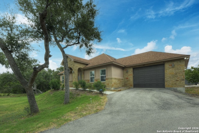 view of front facade featuring a garage and a front lawn