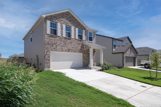 view of front of house featuring a garage and a front lawn