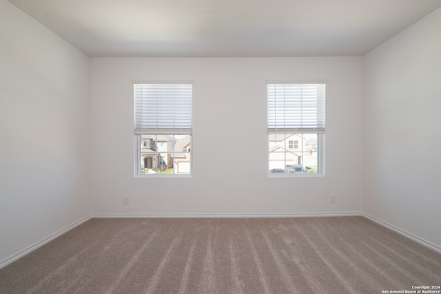 empty room featuring carpet and plenty of natural light