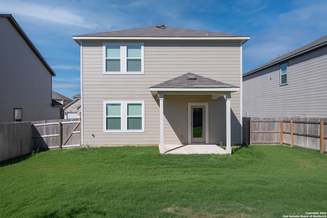 back of house featuring a patio area and a yard