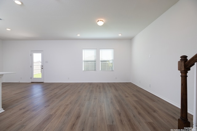 unfurnished living room featuring dark hardwood / wood-style floors