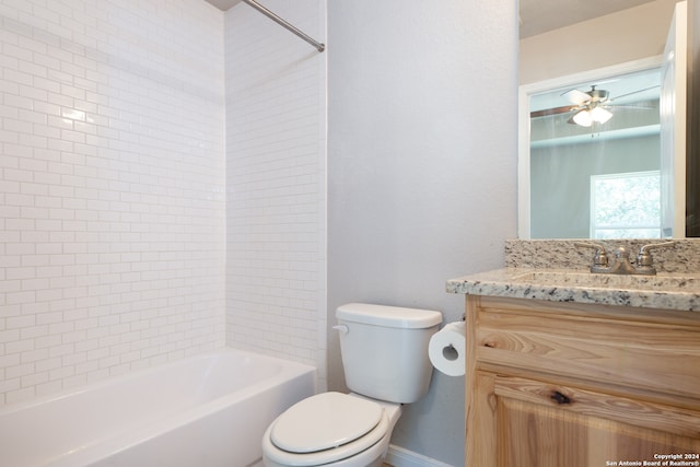 full bathroom featuring ceiling fan, vanity, tiled shower / bath combo, and toilet