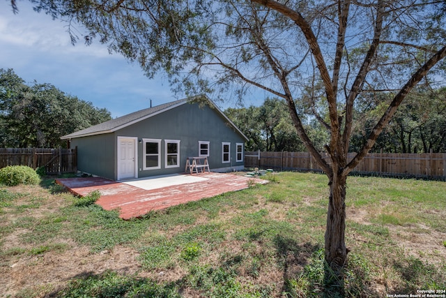 rear view of property featuring a yard and a wooden deck