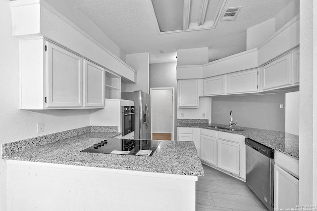 kitchen featuring kitchen peninsula, white cabinetry, sink, and appliances with stainless steel finishes