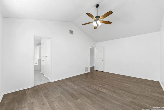 interior space featuring vaulted ceiling, ceiling fan, and dark wood-type flooring