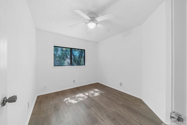 unfurnished room with a textured ceiling, ceiling fan, and dark hardwood / wood-style floors