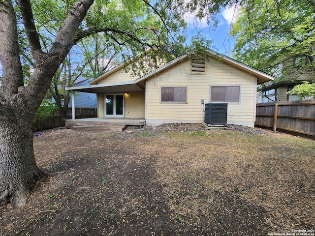 rear view of property with central AC and a patio area