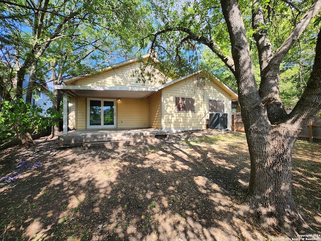 rear view of house featuring central air condition unit and a patio