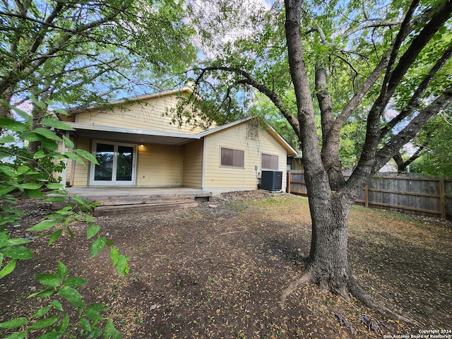 rear view of property with a patio and central AC unit