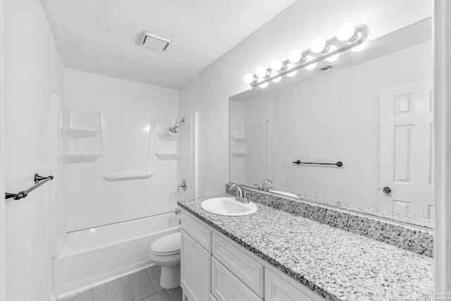 full bathroom featuring vanity, toilet, shower / tub combination, and a textured ceiling