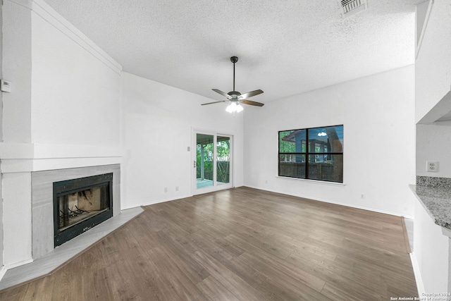 unfurnished living room featuring wood-type flooring, a textured ceiling, and ceiling fan