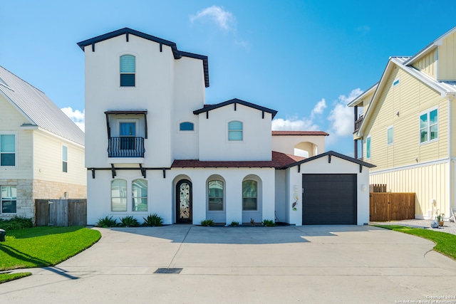 view of front facade featuring stucco siding, driveway, and fence