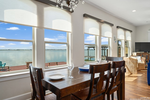 dining space with a notable chandelier and hardwood / wood-style floors