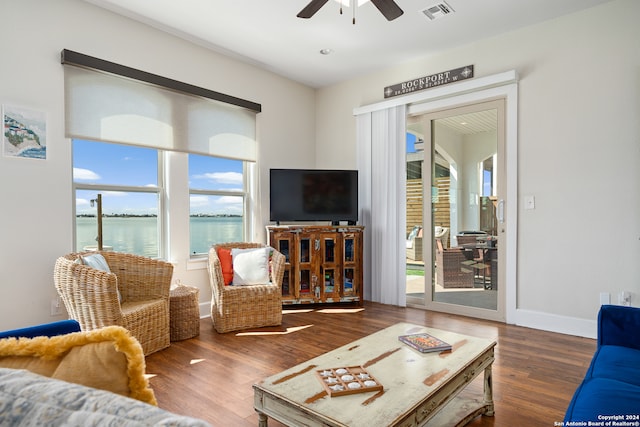 living room with ceiling fan and dark hardwood / wood-style flooring