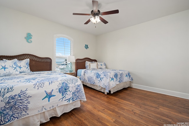 bedroom featuring ceiling fan and dark hardwood / wood-style flooring