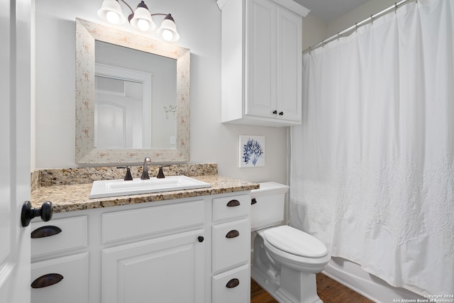 full bathroom featuring vanity, toilet, shower / bathtub combination with curtain, and hardwood / wood-style flooring