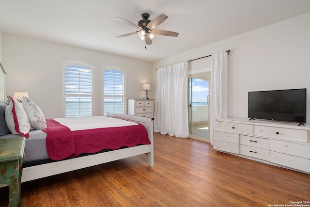 bedroom with wood-type flooring, multiple windows, and ceiling fan