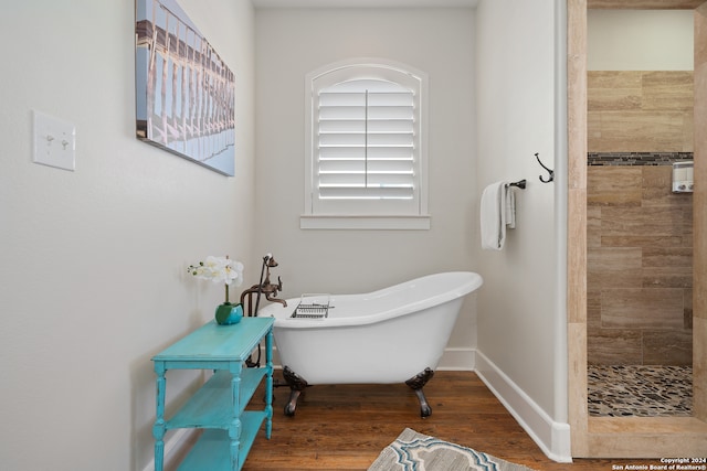 bathroom featuring wood-type flooring and separate shower and tub