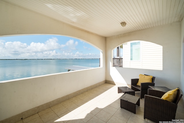 balcony featuring a water view and an outdoor hangout area