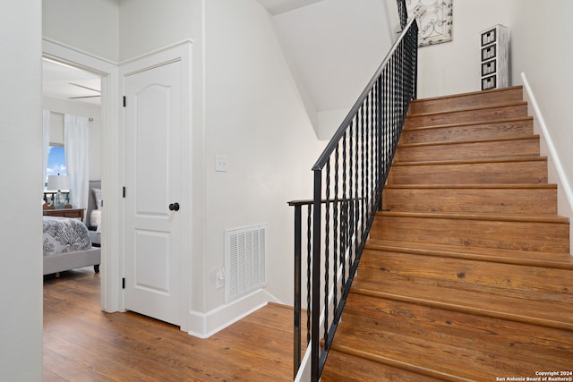 stairs featuring hardwood / wood-style flooring