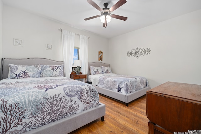 bedroom featuring wood-type flooring and ceiling fan