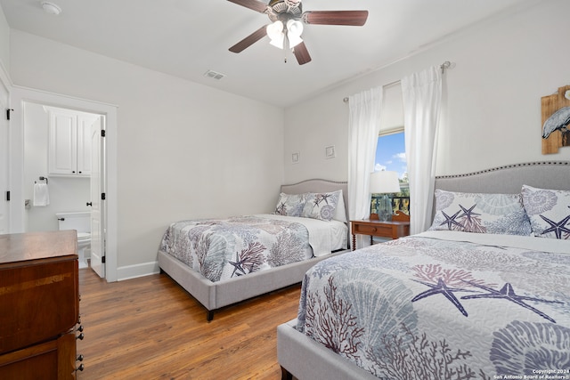 bedroom with ceiling fan, connected bathroom, and hardwood / wood-style floors