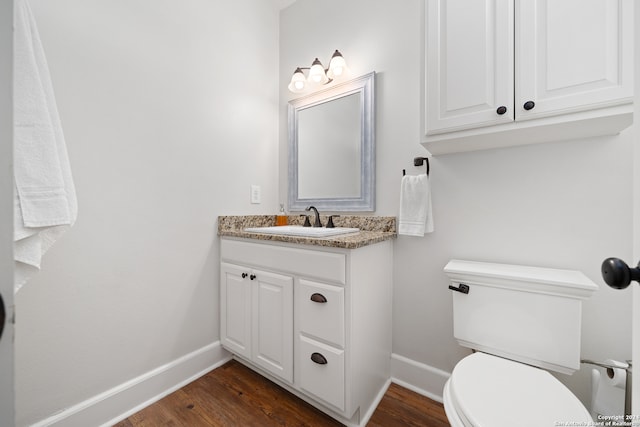 bathroom featuring hardwood / wood-style floors, vanity, and toilet