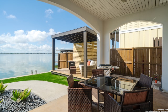 view of patio / terrace with area for grilling and a water view