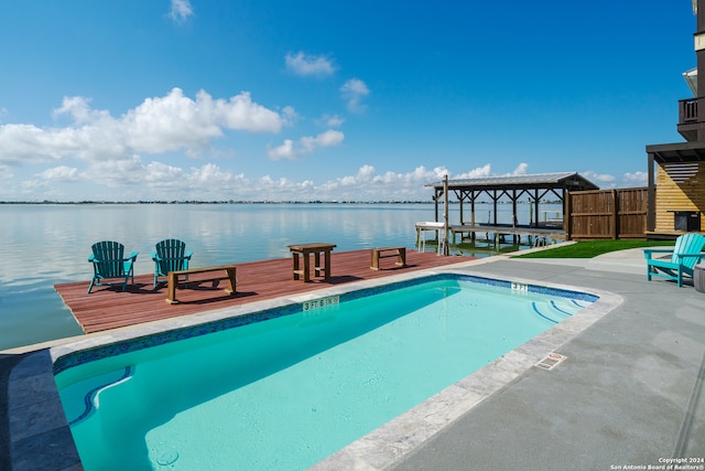 view of swimming pool with a water view