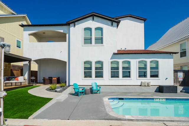 back of house with a balcony, a patio, and outdoor lounge area