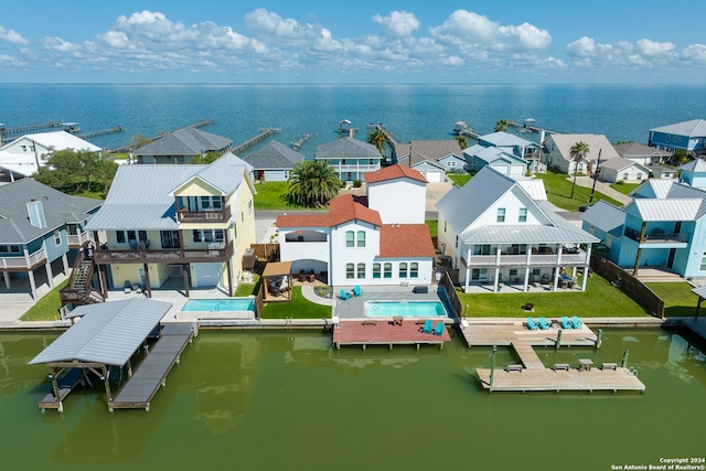 drone / aerial view featuring a residential view and a water view