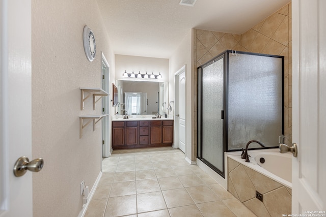 bathroom featuring tile patterned flooring, a textured ceiling, vanity, and independent shower and bath