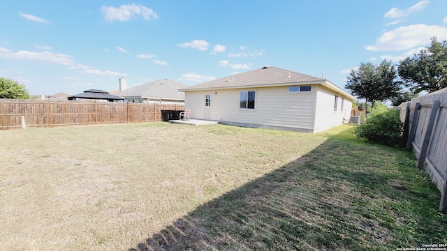 rear view of property featuring a lawn