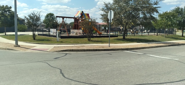 view of jungle gym featuring a lawn