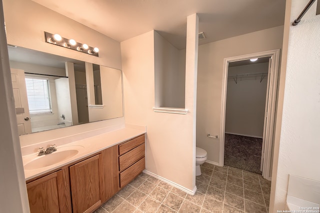 bathroom featuring vanity and toilet